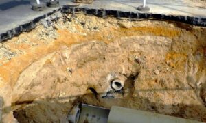 Highway collapse exposed underground pipe - ALTA SURVEY Georgia Road collapse excavation with exposed pipe, explained by a civil engineer