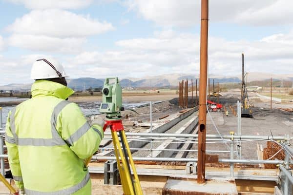 Surveyor conducting an ALTA survey at a construction site in Newnan to confirm boundaries and site conditions
