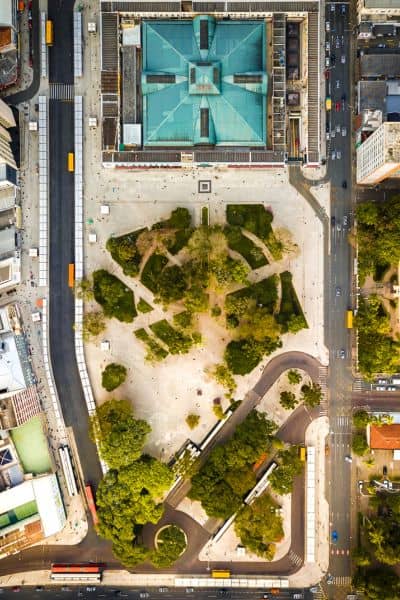 Aerial view of an urban roadway with trees, sidewalks, and intersections used in a topographic survey for a Complete Streets project
