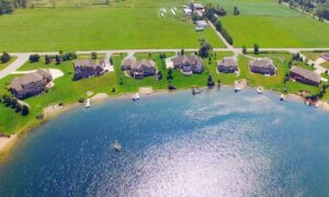Property line survey lakefront homes shoreline - ALTA SURVEY Georgia Aerial view of lakefront homes with docks showing shoreline where a property line survey defines land boundaries