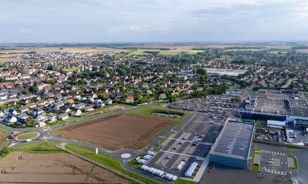 Aerial view of new developments expanding beside established homes, showing how nearby construction can impact property survey boundaries