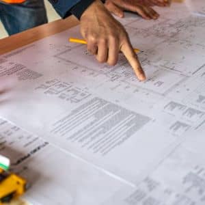 Land surveying data being reviewed on technical plans during early infrastructure planning

