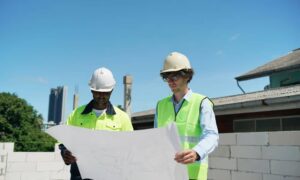 Surveyors reviewing site plans on residential lot - ALTA SURVEY Georgia Surveyors reviewing topographic survey plans to understand site data differences