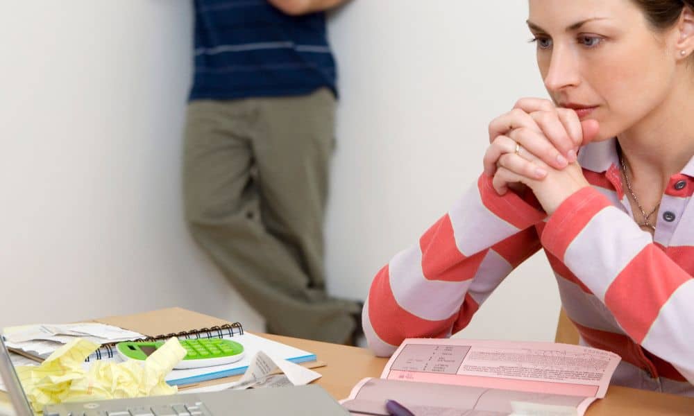 Homebuyer reviewing closing documents after learning the average cost for a land survey