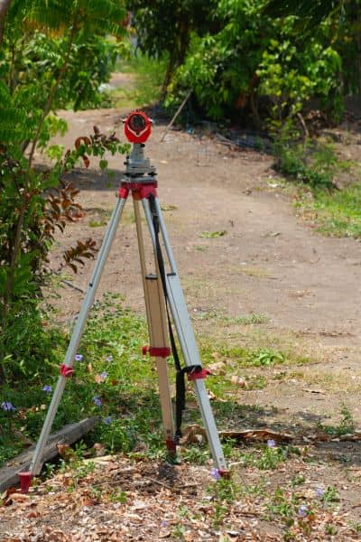 Land survey equipment on tripod - ALTA SURVEY Georgia Licensed surveyor equipment used to measure property boundaries during a land survey