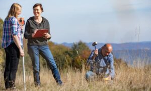 Survey team checking property boundary - ALTA SURVEY Georgia Licensed surveyor marking a property boundary during a land survey