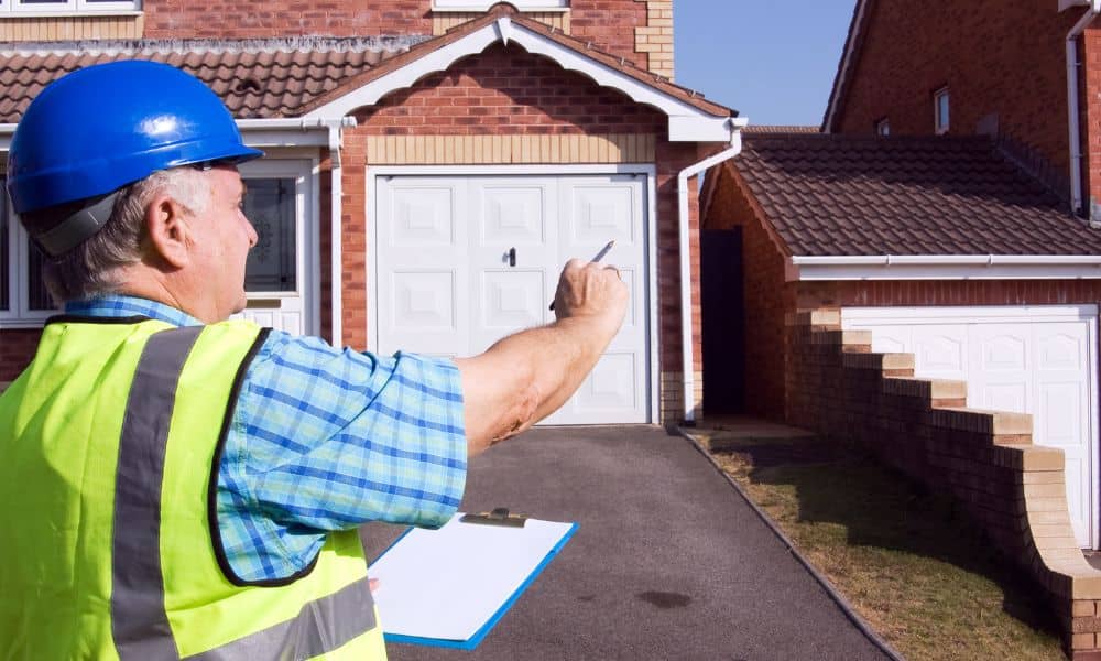 Surveyor reviewing a residential property and driveway before starting a land survey