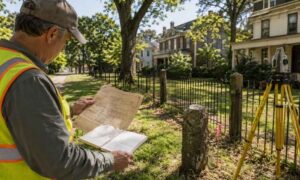 Licensed land surveyor boundary retracement - ALTA SURVEY Georgia Licensed land surveyor reviewing historic records and field evidence during a boundary retracement