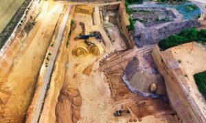 Aerial view of industrial stockpiles and excavation equipment in a LiDAR mapping project