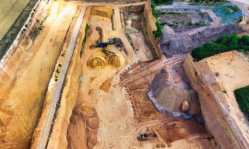 Aerial view of industrial stockpiles and excavation equipment in a LiDAR mapping project